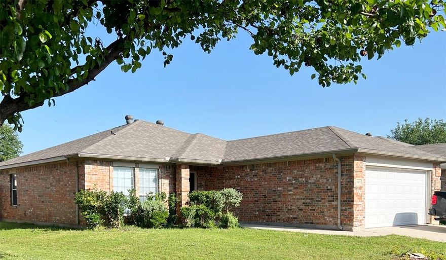 This beautifully maintained 3-bedroom, 2-bathroom home with a 2-car garage is located in the desirable Northwest ISD and offers a spacious, open layout ideal for modern living. Stylish wood plank flooring runs throughout the home, providing both charm and easy upkeep. The kitchen features rich wood cabinetry, striking countertops, and black appliances including a built-in microwave, dishwasher, stove, and disposal. The split-bedroom design offers added privacy, with the primary suite including a walk-in closet and ensuite bath with garden tub. Additional highlights include a full-size utility area with extra storage, a sprinkler system, and a fenced backyard for outdoor enjoyment. Located in a master-planned community that offers access to a sparkling pool and playground, this home blends comfort, convenience, and lifestyle amenities. Only 1 pet under 40lbs allowed with owner approval.