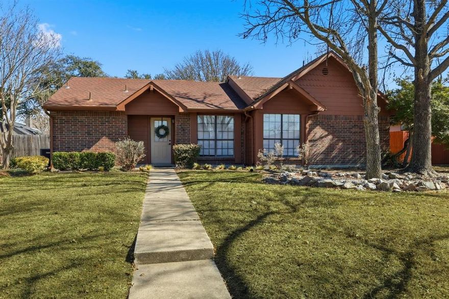 Located in a prime North Dallas area within Carrollton Farmers Branch ISD, this home offers everyday convenience and no HOA. Inside, vaulted ceilings and a gorgeous wood burning fireplace create a spacious, inviting living area. The updated kitchen features sleek cabinetry, generous quartz countertops, a pantry, and a bright breakfast area with a warm wood accent wall and updated decorative lighting. The primary suite includes a walk in closet and refreshed ensuite bath. Hard surface flooring throughout provides a cohesive look with easy maintenance. The secondary bath offers a Jack and Jill style layout with a separate vanity area, ideal for guests or shared use. A huge backyard allows room for pets, play, or gatherings. The attached 2 car garage provides space for vehicles or extra storage, and a bonus basketball goal adds a fun touch. Convenient to restaurants, shopping, the Dallas North Tollway, President George Bush Turnpike, I 35E, Love Field, and DFW Airport. Investors - this one is a good one, ready to go!