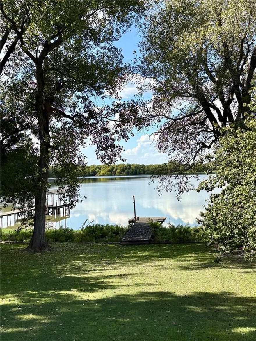 This can be yours in time for Christmas.
Bring the boat!  Rare lakefront property on Lake Waxahachie! Covered deck overlooks the water.  Complete with open boat dock and outbuilding.
This 1977 lakehouse could use a few cosmetic updates but roof was replaced in 2022, plumbing updated 2021 and electrical box replaced in 2024.