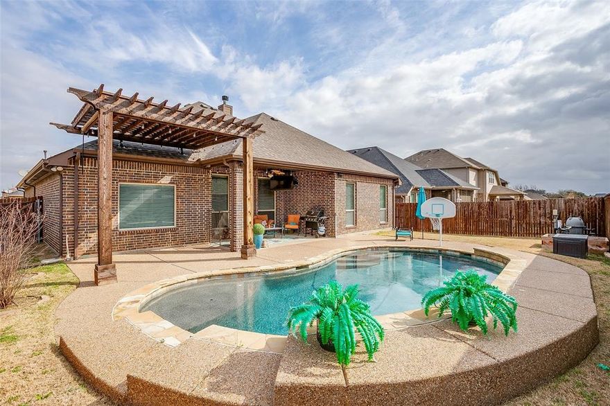 Back on Market! LOWERED PRICE TO SELL!  JUST FOUND OUT THE SELLER'S CORPORATION IS RELOCATING!  CHECK IT OUT ! Everything you could desire  in home complete with pool, covered patio and pergola! Beautiful 4-bedroom, 2-bath, 2 car garage home featuring an inviting open-concept floor plan designed for comfortable living and entertaining.  The spacious living area flows seamlessly into the  kitchen and dining space highlighted by beautiful cabinetry with overhead lighting and large formal dining space with convenient butlers pantry storage and granite coffee bar.  The primary bedroom offers a relaxing retreat with sitting area creating a perfect space to unwind.  Additional bedrooms provide flexibility for family, guests or a home office.  Step outside to your own backyard oasis featuring a sparkling pool with waterfall feature, and pergola, ideal for entertaining or enjoying peaceful evenings.  The covered patio includes a mounted TV and Bose speaker system, child safety fence if needed making it perfect for outdoor gatherings.  Spacious backyard allows for child play area and animals in addition to pool area. Additional features  include insulated garage door, epoxy flooring, with airconditioning unit.  This house is data wired for telecomunications and infastructure needs.This amazing  home combines comfort, style and outdoor living, making it a perfect place to call home!  Don't miss your chance for luxury living. This property is not just a house; it is a lifestyle waiting to be embraced.  Schedule a viewing today to experience all it has to offer. The listing agent is a relative of the seller.