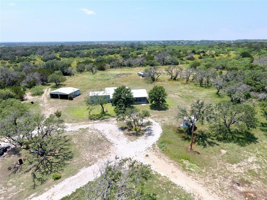 Nice smaller acreage located just minutes south of Goldthwaite on CR 442. Mobile home has metal roof and amazing front porch, has 2 bedrooms, 2.5 baths and 2 living areas. There are 4 mini splits to provide heating and cooling. Master bath has tiled shower area with grab bars. Kitchen features an abundance of cabinet space and pantry for additional storage.

Terrain is gently rolling with home being on the higher elevation giving you a great view from the front porch! Selective cedar clearing has been done leaving scattered live oak cover. Deer are abundant and is why the garden has a high fence around it. Garden is located convenient to the home and well. Water well is estimated to produce approx. 25-30 gpm and be approx. 250' deep. There is a 2 car metal shed for vehicle or equipment storage.

If you have been searching for a place to call home or a weekend getaway call today and schedule a time to take a look!