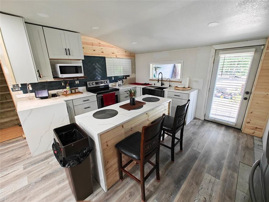 Welcome to this unique opportunity in the growing city of Waxahachie! Situated on a generous almost half-acre lot, this home offers 5 bedrooms and 3 full bathrooms, including two private en-suite bedrooms perfect for multi-generational living, guests, or rental income. The property has seen several updates, including a remodeled kitchen featuring a large island, modern farmhouse sink, and stainless steel appliances. With a little more work, this home could become a true gem. Enjoy the flexibility of multiple living areas, a detached garage, a large back yard, and plenty of space for your toys, RV, or future expansion. The lot and layout provide amazing potential for buyers looking to invest or personalize.