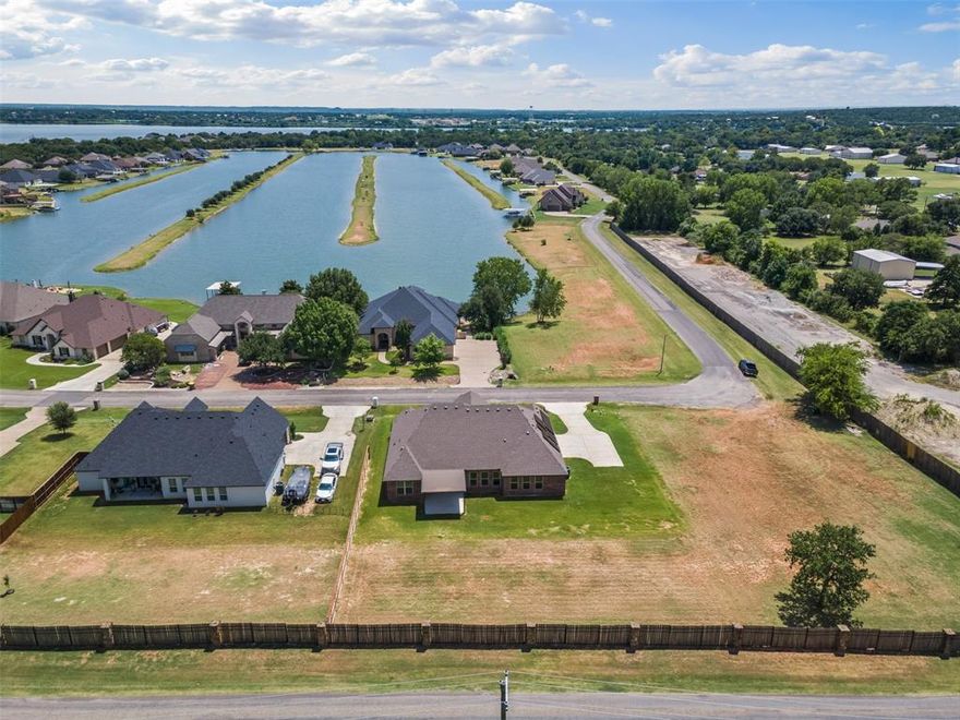 Welcome home to this pristine GATED SKI LAKE community!! 1to1 BUY DOWN with preferred lender......This newer very well cared for 4bed plus office 3 full baths, open concept, split floorplan on almost a half acre is awaiting you. Plenty of space to build your SHOP, POOL or both plus more!! Vaulted ceiling in living room complete with wood beam for added character, electric fireplace, and crown molding throughout. Tall picture windows bring in the natural light. Gorgeous chef kitchen with large island, plenty of granite countertop space for your cooking and entertaining needs complete with large walk in pantry. Tile throughout except carpet in bedrooms. Gorgeous coffered ceiling in master bedroom complete with a huge 15 x 6 walk in closet. Master bathroom has a spa like feel with a large walk in shower, hollywood stand alone soaking tub, separate vanities. Office has a closet so could be 5th bedroom if needed. The unique ski lake allows for so many outdoor activities like fishing, skiing, kayaking, paddleboarding, swimming, and of course skiing. WOW.....6 of the last 13 months the electric bill was ZERO!!!Seller giving $10k credit towards solar balance with acceptable offer. ONLY 40 minutes from Fort Worth. Enjoy LAKE LIFE in Granbury TX voted #1 Historic Small Town by USA Today FOUR Times!!!!