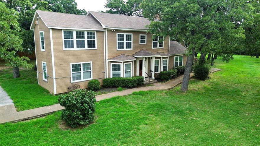 Discover timeless charm and modern versatility in this distinctive 1930s two-story estate nestled in the historic Handley Heights neighborhood. Offering a combined 3,518 sq. ft. of space—including the 2,238 sq. ft. main residence and an additional 1,280 sq. ft. outparcel building—this property delivers exceptional flexibility for both personal and professional use.

Inside the main estate, original hardwood detailing and two elegant wood-burning fireplaces showcase its vintage character, while thoughtful upgrades—such as central heating and air, soaring ceilings, and 24-hour surveillance—provide modern comfort and security.

Zoned ER (Neighborhood Commercial Restricted), the property offers endless possibilities—from a private residence to a business headquarters, creative studio, wellness center, or a mixed-use investment opportunity. The main home features seven private suites, three restrooms, and multiple common areas, allowing for a wide variety of functional layouts.

The 1,280 sq. ft. outparcel building expands your options even further—perfect for additional workspace, rental income, storage, or future development.

Located near major thoroughfares, the estate provides prime visibility and convenient access, making it an ideal opportunity for entrepreneurs, professionals, and investors seeking to capitalize on Fort Worth’s dynamic growth.