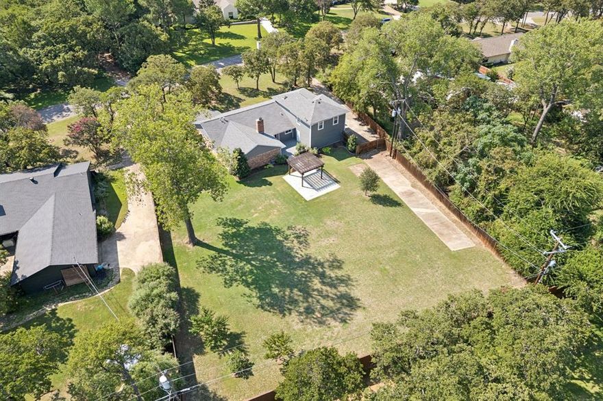 OPEN HOUSE ON 02-14 SATURDAY AT 12-4PM! *MASSIVE .6+ ACRE LOT IN KELLER ISD!*NO HOA!*BEAUTIFUL UPDATES THROUGHOUT!* Nestled in a serene, established community, this impressive 1.5-story residence radiates timeless charm and modern sophistication. Mature trees, manicured landscaping, and stately curb appeal set the tone, while inside, thoughtful updates and upgrades elevate every space.

The home’s elegant interior has been fully repainted (2021) and showcases wood-look flooring, crown molding, and abundant natural light. A 2019 full remodel transformed the kitchen into a masterpiece, featuring white cabinetry, a striking tile backsplash, stainless steel appliances, and a 5-burner cooktop with vent hood, and a pot filler. The massive walk-in pantry with custom cabinetry and counterspace is truly unmatched. The kitchen flows into the living room, where vaulted wood-beamed ceilings, a gas fireplace, and custom built-ins with floating shelves create a luxurious gathering space.

Retreat to the primary suite, freshly updated with recent carpet (2025), a sliding barn door, spa-like ensuite with a dual vanity, pendant lighting, and a custom walk-in closet system. Secondary bedrooms are equally versatile—one with dual closets and built-ins, another with LVP flooring (2023), and a flexible 4th bedroom or office with walk-in closet. Upstairs, a sprawling game room with walk-in closet and full bath offers endless lifestyle options.

Outside, the huge backyard is a quiet oasis, enhanced by mature fruit trees (2 peach, 1 plum, 1 fig) and raised garden beds. The property also offers an automated 13-zone sprinkler system with rain sensor.

Additional highlights include a 2019 tankless water heater and majority home automation, including smart switches and exterior lighting. With NO HOA, Keller ISD schools, and a prime location close to shopping and dining yet tucked away for peace and quiet, this home is a rare blend of comfort, elegance, and modern convenience.