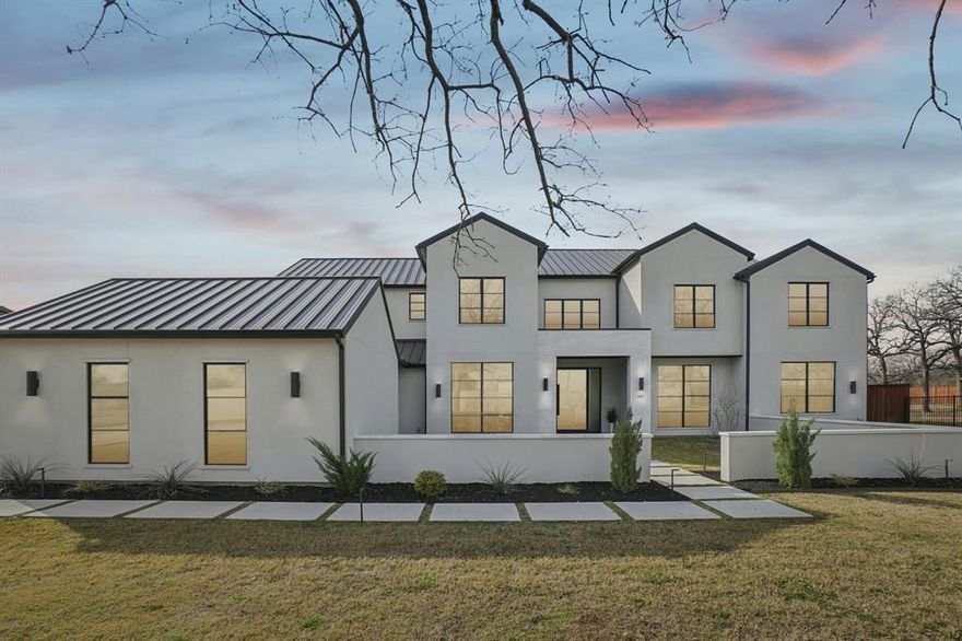 Nestled on a sprawling, private lot of over an acre, this exceptional new home built by Calais Homes offers luxury, space, and thoughtful design at every turn. An electric gated driveway ensures privacy and leads to an impressive 4-car garage. Boasting 6 bedrooms, 7 full bathrooms, and 2 half baths, this home is designed for both everyday comfort and grand-scale entertaining. The great room features an elegant electric fireplace and a dramatic wall of windows that frame serene backyard views. The formal dining room is complemented by a temperature-controlled wine room, perfect for hosting memorable gatherings. The chef’s kitchen is a true showstopper with a built-in refrigerator, commercial-grade gas cooktop and vent hood, oversized island, and abundant cabinetry. A fully equipped prep kitchen provides a second sink, dishwasher, microwave, refrigerator, electric range, and walk-in pantry—an ideal staging space for dinner parties and events. The serene owner’s suite overlooks the pool and showcases a coffered ceiling and a spa-like ensuite with dual vanities, dual toilets, dual custom walk-in closets, an oversized walk-in shower with dual shower heads, and a freestanding soaking tub. The main level also offers a game room with wet bar, media room, and a versatile flex room ideal for a home gym or second study. Upstairs, enjoy a second game room with balcony access overlooking the Texas-sized yard, along with four generously sized bedrooms, each featuring its own ensuite bath. Step outside to a private backyard retreat complete with a sparkling pool, fire pit, covered patio with outdoor kitchen, and expansive green space—perfect for relaxation and entertaining. Ideally located in Southlake, just minutes from Southlake Town Square’s premier shopping and dining, and directly across from The Marq offering tennis courts and additional recreational amenities, this remarkable home delivers luxury living at its finest.