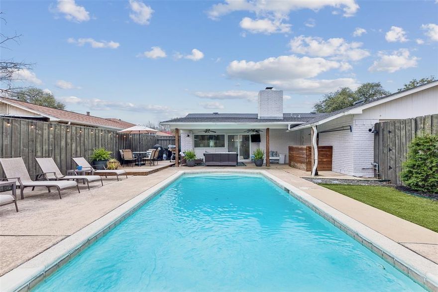 Tucked in an established East Dallas neighborhood just minutes from White Rock Lake, this updated home blends an open, light-filled layout with a backyard retreat featuring a pool, covered patio and plenty of space for outdoor entertaining. The large picture window above the kitchen sink frames views of the sparkling pool and backyard, bringing natural light into the heart of the home. The kitchen features granite countertops, stainless steel appliances and a separate butler’s pantry area with generous storage—perfect for a coffee bar, beverage station or additional prep space. The flexible open floor plan allows for a variety of living arrangements with space for dining, a home office or multiple living areas anchored by a cozy gas log fireplace. The spacious primary suite easily accommodates king-sized furniture and includes a walk-in closet and private bath. Both bathrooms have been updated and all bedrooms feature carpet for added comfort. Step outside to the standout feature of the home—an inviting backyard designed for enjoying the best of Texas outdoor living. The covered patio, sparkling pool and wood deck create the perfect setting for relaxing evenings, grilling and alfresco dining with friends and family. Recent improvements include roof (2020), windows replaced (2024), furnace (2025), pool pump (2025) plus exterior brick paint and a replaced front door within the past few years. Enjoy the lifestyle that makes East Dallas so desirable with easy access to White Rock Lake’s miles of scenic trails, kayaking, biking and sunset walks, as well as the Dallas Arboretum’s gardens, concerts and seasonal festivals. Lakeland Hills Park is just around the corner and offers an 8-acre park with walking trails, tennis courts, playground, skate park and a dog park with separate areas for large and small dogs. Conveniently located about 10 minutes from Lakewood Shopping Center and with easy access to I-30 for commuting to Downtown Dallas and beyond.