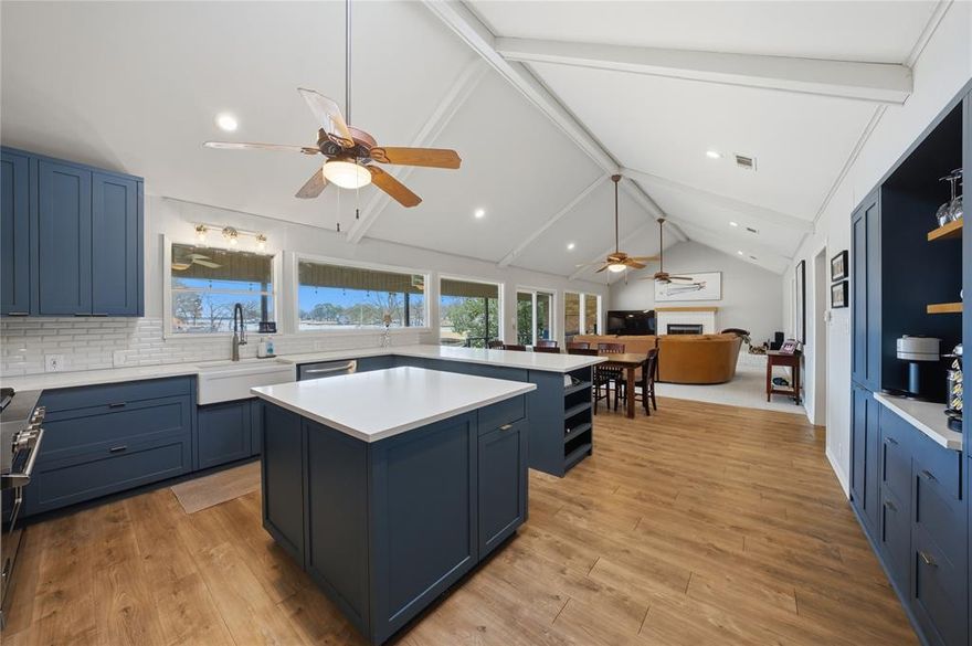 Charming, tastefully updated, and ready to enjoy!  The main house offers two bedrooms and two baths with an open-concept design, vaulted ceilings, a cozy fireplace, and large picture windows showcasing wonderful lake views.  The spacious kitchen features gas cooking, a center island and an oversized eating bar - perfect for gathering and entertaining.  A versatile bunkhouse adds extra space for sleeping or gaming and includes a full bath.  Outdoor living truly shines with a large covered porch complete with a fireplace, plus a generous boathouse with a party deck, all nestled on deep water in a picturesque cove.