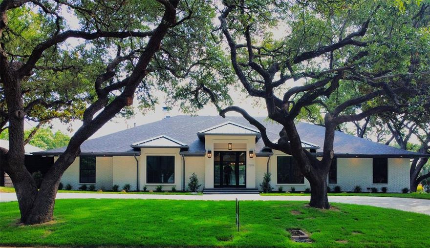 Experience luxury in this exquisite 6-bed, 4.5-bath single-story estate on over a third of an acre in Windsor Park, Preston Hollow. The home features a striking drive-up appeal with a large, shaded circular driveway under majestic live oak trees, striking elevation with stucco accented entry and bay windows, and sleek metal roof accents. Inside, the versatile open-concept floor plan is perfect for entertaining, with a dedicated home office, elegant white oak floors and 10-ft ceilings in kitchen, living, dining areas. The spacious dining room is ideal for gatherings. The split-bedroom layout offers privacy, making it perfect for a mother-in-law suite, gameroom or secondary living area. The chef’s kitchen boasts a 48 inch gas range, built-in refrigerator, freezer, icemaker, extra water hookup in pantry for coffee machine, custom cabinetry with soft closing hinges and slides, large pot and pan drawers, spice drawer pullouts, tray storage, trash drawer, and lazy susans. The owner's suite includes a spa-like bath with a floor-to-ceiling tiled shower, a 6-ft soaking tub, towel warmer, grooming drawer, and dual closets with built-ins. A secondary laundry adds convenience. Elegant powder bath with floating vanity, led under cabinet lighting, and floor to ceiling tiled accent wall. The main laundry room is complete with a utility sink, space for an extra freezer or refrigerator and a separate supply closet. Whole house water filter system and reverse osmosis filter system are installed at the kitchen sink. USB outlets in all rooms for charging your electronic devices. Plugs at primary bath and guest bath water closet for future bidet seats. Outside, enjoy a pool-sized yard with new landscaping, an 8-ft BOB fence, and a sliding gate for extra security and privacy, all on a third of an acre corner lot. All of the hard work has been done and this house is truly move in ready. Improvements are too much to list, see docs for list of renovations. Seller is licensed broker.