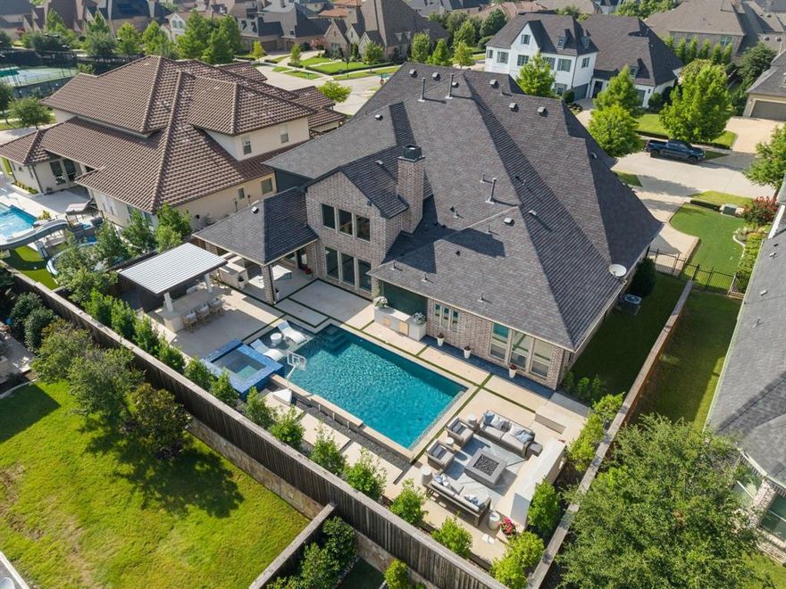 Stunning 5k+ sf home with fabulous backyard in Frisco's most desirable gated neighborhood, Newman Village! Gorgeous brick with cast stone trim, large covered front porch, front 3-car swing garages & beautiful curb appeal leads you to a grand entry through a custom front door. Designer finishes and numerous upgrades throughout! Soaring ceilings, a curved staircase with custom risers and a breathtaking chandelier greet you upon entry. The ideal floor plan, a private downstairs guest room w ensuite bath & walk-in closet is at the front of the home. Flexible formal dining room or sitting area features a butler's bar pass through to the dreamy kitchen with oversized breakfast bar island, white quartz countertops, double ovens, built-in fridge, 6 burner stove and white painted cabinetry. The adjacent breakfast nook is a large dining area with terrific views of the resort-style backyard. The wall of windows continues into the spacious, neighboring family rm with 2-story ceiling, custom beams, marble stacked stone fireplace & built-in, floating entertainment console. Huge downstairs media! The study is conveniently just off the oversized private master bdrm with sitting room, backyard views & luxe master bath. Upstairs is a large game room and 3 generous-sized bedrooms each with their own bath and walk-in closets. The show-stopping backyard is ideal for entertaining family & friends with every feature imaginable including a covered patio with built-in outdoor kitchen, separate covered bar area for entertaining, massive pool with tanning ledge, spa, & water features, additional seating area with built-in tv all surrounded by beautiful landscaping featuring extensive landscape lighting. Newman Village is a premier guard-gated neighborhood with convenient access to DNT, 2 mi from PGA Frisco & mere minutes to shopping, dining and entertainment in every direction! Amenity-rich community with pool, tennis, pickleball, central plaza, social activities, jogging paths and more!