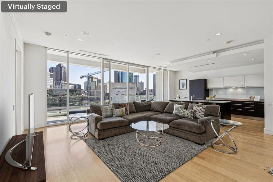 Stunning luxury condo at W Dallas – Victory Hotel & Residences featuring one of the most sought-after northwest-facing views. Enjoy sweeping city and skyline vistas from the expansive patio-style balcony, perfectly positioned for unforgettable sunsets and downtown scenery. At the heart of the home is a spacious living room flooded with natural light, seamlessly connecting indoor living with the outdoor balcony and its incredible views.  The sleek, modern kitchen offers a large island, abundant cabinetry, and clean contemporary lines—ideal for both everyday living and entertaining. Rich bamboo flooring adds warmth and sophistication throughout the open-concept floorplan. The residence is impressively spacious and features two large bedrooms, each with its own ensuite bathroom and walk-in closet, providing privacy and comfort for owners and guests alike.  The primary suite is a true retreat with a custom-designed closet and a spa-like ensuite bath complete with dual vanities, a soaking tub, and a separate walk-in shower. A full-size front-load washer and dryer are conveniently located in a utility closet with additional storage cabinetry.  Residents enjoy world-class, amenity-rich living including 24-hour concierge service, a fully equipped fitness center, a stunning resort-style pool, and beautifully designed outdoor entertaining areas with built-in grills. The nearby Goldman Sachs tower currently under construction (estimated completion 2028) still allows for wide, open downtown views.  Ideally located just one block from American Airlines Center and moments from the Katy Trail, with exceptional dining, shopping, and entertainment all close by. Schedule your private showing today and don’t miss this exceptional opportunity to own in one of Dallas’ most iconic buildings.