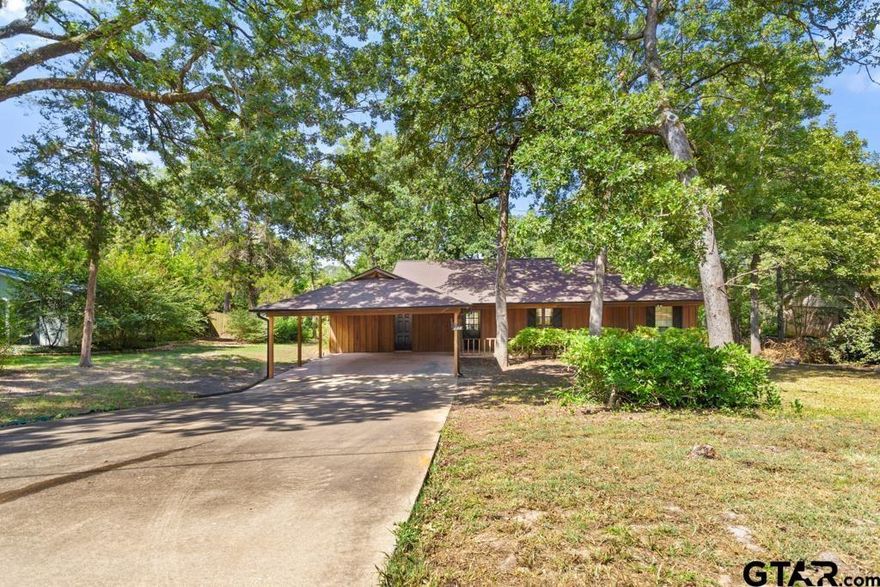 This home has so much potential and offers an affordable entry price point into the popular Hideaway Lake and Golf Community in East Texas! Brand new roof and gutters have been installed, re-stained deck and rear of home! This cute three bedroom, 2 bath cabin style home with two car carport awaits you. Open concept living floor plan with large combination kitchen-dining-living area. Split master bedroom with large walk-in closet. Two good sized guest rooms share a full bathroom on the other side of the home. Large outdoor living space with both covered patio and open deck offering elevated views of the backyard. Storage building on lower part of backyard. Hideaway is an active lifestyle lake and golf community featuring 27 holes of golf, 2 full recreation lakes, swimming pools, parks, sports courts, pro shop and bar and grill amongst the many amenities. AND Hideaway feeds into the award winning Lindale Independent School District