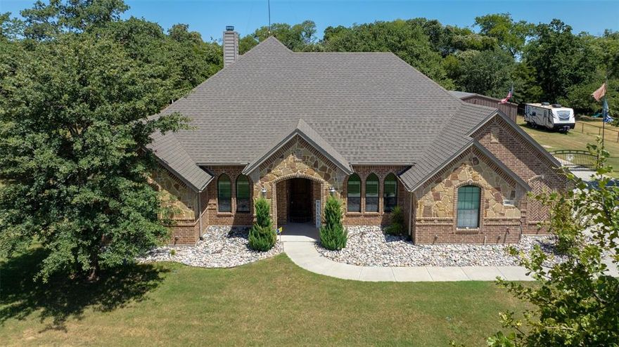 Discover an extraordinary lifestyle in this stunning 4-bedroom, 3.5-bathroom masterpiece nestled within the prestigious Knob Hill Estates. Set on a sprawling one-acre lot, this elegant residence blends sophistication with modern comfort. Inside, you’ll find refined touches like plantation shutters, rich hardwood floors, sleek granite countertops, and top-of-the-line stainless steel appliances, complemented by a water-circulating pump for instant hot water convenience.

Embrace outdoor living at its finest with a beautifully enclosed screened patio featuring a cozy fireplace, perfect for intimate gatherings. The heated saltwater pool invites year-round enjoyment, with a max depth of 5ft it is perfect for some hydrotherapy. While a charming 400 sq. ft. guest cottage offers versatile space for visitors or additional storage. For hobbyists or those needing extra room, the property includes a meticulously designed 30x40 spray foam-insulated workshop, complete with electricity and a private bathroom.

With RV parking and hookups, this home effortlessly combines rural serenity with modern practicality. Located just 15 minutes from vibrant shopping, dining, and the scenic Eagle Mountain Lake, and a mere 45-minute commute to downtown Fort Worth, this residence offers the best of both worlds. Don’t miss your chance to own this unparalleled haven of luxury and tranquility—schedule your private tour today!