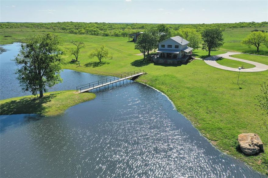 Located in northwest Jack County just east of Antelope, this 330 plus acre ranch offers a combination of improved pasture, water features, and functional improvements suited for ranching, recreation, or multi generational living.

The main residence is a 1,671 square foot two bedroom, two bath story and a half log cabin style home. The interior includes a full kitchen, wood burning stove, and an eat in dining area. A wrap around deck overlooks a scenic 2 acre lake positioned near the home. In addition to the primary residence, the property includes a 60 x 40 barndominium. The structure contains approximately 1,920 square feet of living space and 1,440 square feet of insulated shop and warehouse space. The first floor features an open concept layout with kitchen, living area, restroom, and office. Upstairs are two bedrooms, a workspace and office area, and access to a balcony overlooking the lake.

The main home, barndominium, and lake are situated within a pipe fenced compound of approximately 25 acres. Improvements include working pens, cross fencing, and an additional stock tank. The ranch has significant paved frontage along FM 174 with multiple gated entrances. An additional 48 acres lie across FM 175, with Bowen Loop forming the north and west boundaries.

Water is supplied by a well producing approximately 13 gallons per minute at around 145 feet. Both residences are serviced by the well. Electric service is provided by J A C Electric Cooperative. An agricultural tax exemption is currently in place.

Seller intends to convey all owned mineral rights, believed to be approx. one third of the mineral estate. No active mineral production is present on the property.

The land features sandy loam soils, gently sloping terrain, and a mix of open areas and wildlife habitat. Native game in the area includes whitetail deer, turkey, and hogs. This property is well suited for buyers seeking a functional ranch with established improvements already in place.