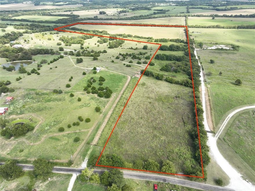 Scenic 56 acre tract in Sherman, TX. It offers lots of elevation changes providing great views and character to the property. This would be an awesome spot to build a home, a weekend getaway, or even just to have some land to enjoy. There is a water meter in place so you could immediately build. Currently the property is being leased for row crop production and cattle allowing for an AG exemption.