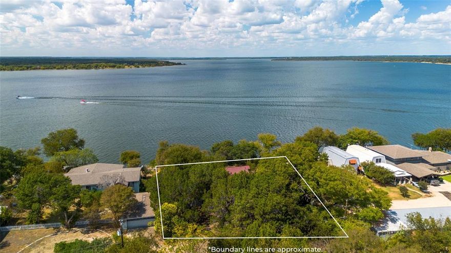 Escape to this charming rustic cabin-style home overlooking beautiful Lake Whitney. Tucked away on a quiet dead-end road, this property offers peace, privacy, and direct lake access via a scenic trail through Corps of Engineer land. Step inside and enjoy the warm, cabin feel with hardwood floors and carpet, wood finishes and cozy spaces. The roof was just replaced in 2026, along with replacing an exterior screen door for added peace of mind. The bright sunroom is the perfect place to relax and take in the lake views year-round. The home features a primary bedroom plus a loft area with three twin beds, ideal for guests or a fun bunk space for kids. Outside, a detached garage provides extra storage for lake toys, vehicles, or a workshop. Whether you're looking for a weekend retreat or a full-time lake getaway, this property combines rustic charm with unbeatable lake views.