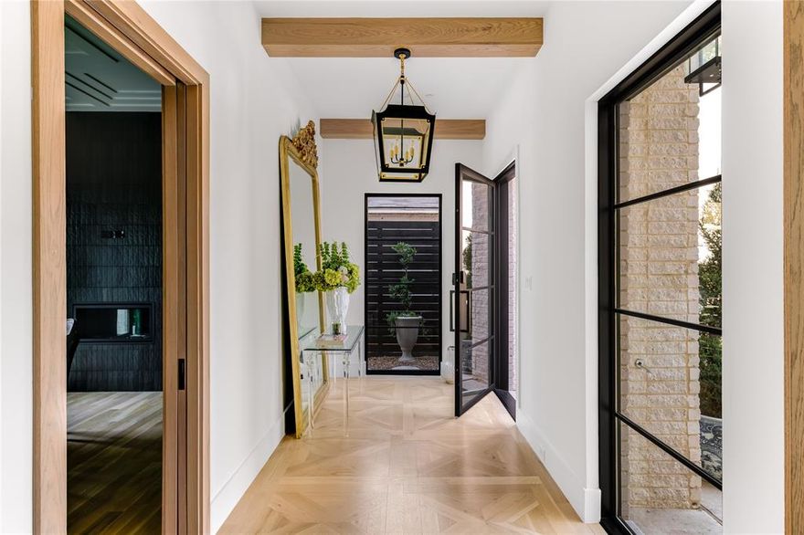 This 2021-Built West HP home showcases amazing upgrades inside and out! The dining room exudes elegance with designer wallpaper and draperies, and a posh fireplace. Nearby is a sophisticated powder bathroom with marble sink and superb fixtures. White oak hardwood flooring, exquisite lighting, and an abundance of natural light flow throughout. The living areas offer dramatic ceilings with wood beams and brick elements, and custom draperies flank the steel doors and windows that overlook the backyard accented by Lambert’s landscaping. The gourmet kitchen includes a marble slab backsplash, black soap stone waterfall island, and Thermador appliances as well as a serving center, walk-in pantry, and butler’s pantry. Primary bedroom with a separate sitting room or workout space offers flexibility. Stunning bathroom with steel pocket doors highlights double vanities, marble encased tub, and shower. Two ensuite bedrooms and chic laundry room.