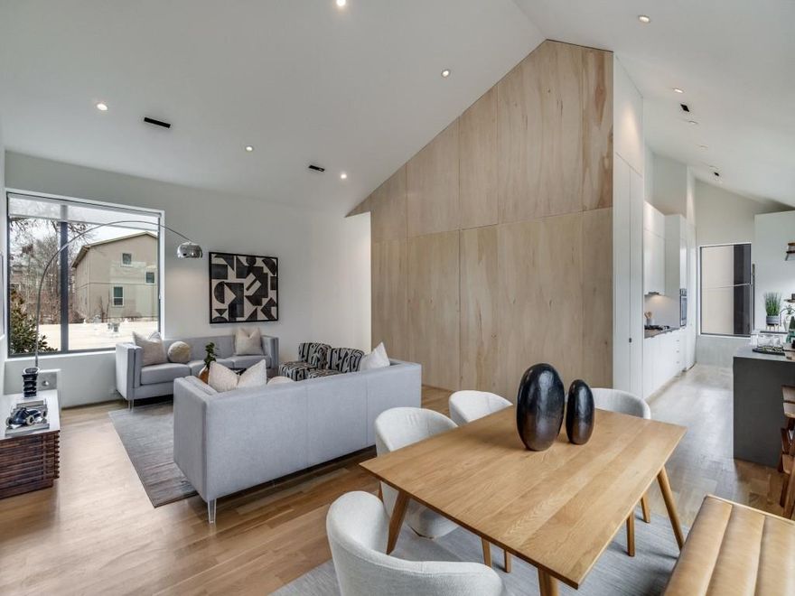 Award-winning architecture by Far + Dang and expert craftsmanship by Alan Kagan define this striking contemporary corner residence in the heart of the vibrant East Village. Thoughtfully designed and filled with natural light, this 2-bedroom home blends modern sophistication with warm livability. The first-floor primary suite offers a private retreat complete with a spa-inspired ensuite bath featuring dual vanities, a walk-in shower, and generous closet space. Upstairs, soaring 14-foot ceilings and expansive windows create a dramatic, airy living space with abundant storage throughout. The sleek chef’s kitchen is designed to impress, showcasing stainless steel appliances, a gas cooktop, and clean modern lines that complement the home’s architectural aesthetic. A second bedroom and a hidden bonus room—ideal for a work-from-home office, studio, or flex space—add versatility. Outdoor living is just as inviting, with a private yard featuring a deck and low-maintenance turf—perfect for entertaining or relaxing. A two-car garage provides convenience and additional storage. One of only three residences on a quiet, tree-lined street, this exceptional home offers rare privacy while being moments from major highways and some of the area’s best dining, entertainment, and neighborhood favorites.