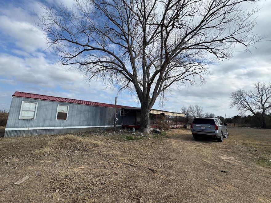 1.17 acres on corner lot. 3 bedroom, 2 bath mobile home that has been updated. Huge covered front porch and smaller back porch. Workshop with electricity. Nice kitchen with lots of white cabinets, vinyl plank flooring and granite tops. Split bedroom arrangement. Master has large walk in tiled shower. Large dining with decorative lighting and vinyl plank floors.