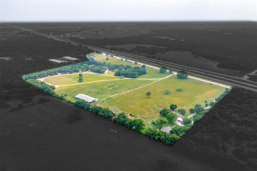 Commercial or Residential development opportunity! 1,700 feet of IH 35W road frontage.  Beautiful 37 acre property with great balance of pasture and trees. Outside city limits and is not zoned to any specific use.  Offers multiple potential uses. Suitable for development, raising cattle, equestrian, other forms of livestock, improved pastures, and building your homestead. The property has 5 buildings currently being rented out as well as a double-wide mobile home and a single-wide mobile home on the property that can be income producing.