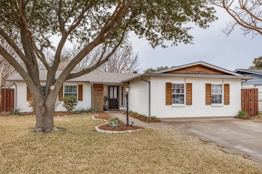 Located in Lake Highlands just minutes from White Rock Lake, this charming home offers a true 3-bedroom, 2-bath main residence plus a fully finished detached ADU — perfect for a private home office, guest quarters, epic kids’ playroom, creative studio, or potential 4th bedroom setup.

The home offers 1,559 SF of light-filled living space with thoughtfully updated finishes throughout. Fresh interior and exterior paint, along with beautifully refinished hardwood floors, create a crisp, move-in-ready feel. The kitchen features granite countertops and stainless steel appliances, while double-pane windows enhance comfort and efficiency. Wood-look ceramic tile flooring, a full sprinkler system, and an updated roof complete the package.
Curb appeal shines with a well-manicured yard and mature trees, setting a welcoming tone from the moment you arrive.

In addition, the property includes a fully finished detached guest quarters adding approximately 318 SF of living space. The space features a kitchenette, full bathroom, and a spacious 20x17 upstairs room filled with character and ready for your vision. The exterior climbing wall and backyard firepit create a fun and functional extension of the home, delivering true outdoor living and incredible flexibility for a variety of living arrangements, home office use, creative space, or even a small home business. Alley access offers future potential for rear garage construction if desired.

A thoughtfully updated home with versatile bonus space in one of Lake Highlands’ most desirable pockets.