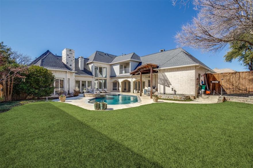 Perfection awaits in this impressive home. Boasting private outdoor spaces and over $200,000 in upgrades within the last two years, it is sure to please. If the home isn't enough, you'll fall in love with the neighborhood. Spanish Oaks of Starwood is a beautiful, gated community with first-class amenities, mature trees, and rolling hills.

An expansive, open floor plan offers panoramic backyard views, featuring a sparkling heated pool, a large yard with mature, lush trees, and an outdoor kitchen, perfect for warm days and nights with family and friends. The gourmet kitchen, at the heart of the home, boasts a Fisher & Paykel five-burner stove and updated finishes. It seamlessly flows into the inviting family room, complete with a stunning fireplace for cozy evenings. The primary suite is a tranquil retreat with an oversized ensuite adorned with recently updated Blanco Carrara marble tile, creating a spa-like ambiance. The living room features a full-sized bar with a wine refrigerator and ice maker, surrounded by exquisite custom woodwork and soaring 20-foot cathedral ceilings, creating an intimate yet dramatic focal point. Spacious secondary bedrooms offer individual ensuites and large walk-in closets.

Ideally situated in the highly acclaimed Frisco ISD and moments from The Star, Legacy West, and North Dallas' premier shopping and dining, this extraordinary home offers exclusivity and convenience. Don't miss your chance to own this Starwood masterpiece—where luxury, elegance, and prime location converge.  Motivated seller.