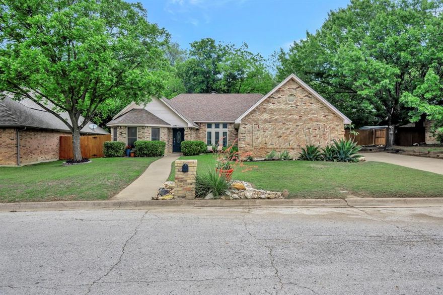 This spacious single story home offers over 2,000 square feet of comfortable living on a generous quarter acre lot in a convenient Fort Worth location. The inviting living room features exposed beams and a brick wood burning fireplace that creates a warm and welcoming focal point. Laminate flooring flows through the main areas, adding both style and easy maintenance. The kitchen is well equipped with an electric cooktop, oven, microwave, and a breakfast bar that opens to the living space, making it ideal for everyday living and entertaining. A dedicated office with a bay window provides the perfect spot for working from home or a quiet retreat. The primary suite is a relaxing escape with trayed ceilings, dual vanities, a garden tub, separate shower, and a walk in closet. Step outside to a large backyard with a covered patio that is perfect for enjoying the outdoors. Conveniently located with easy access to I30 and I820, this home offers both space and accessibility. Schedule your private showing today and come see everything this home has to offer.