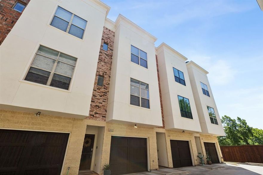 Experience elevated urban living in this sleek and modern 3-story townhouse in downtown Fort Worth's Sundance Square. Designed for both style and efficiency, this smart home features 2 spacious bedrooms, 2.5 beautifully appointed baths, quartz countertops, rich mahogany cabinetry, and stainless steel appliances. Gorgeous wood floors flow throughout the open-concept main living area, creating a warm and inviting atmosphere. Enjoy seamless everyday living with integrated smart home features that add convenience and energy efficiency. Step out onto the balcony for a breath of fresh air or head up to the private rooftop deck to take in stunning views of the Fort Worth skyline. An oversized tandem garage offers parking for up to 3 cars—perfect for city living. Whether you're entertaining guests or enjoying a quiet night in, this home offers the perfect blend of modern design, thoughtful updates, and unbeatable location.