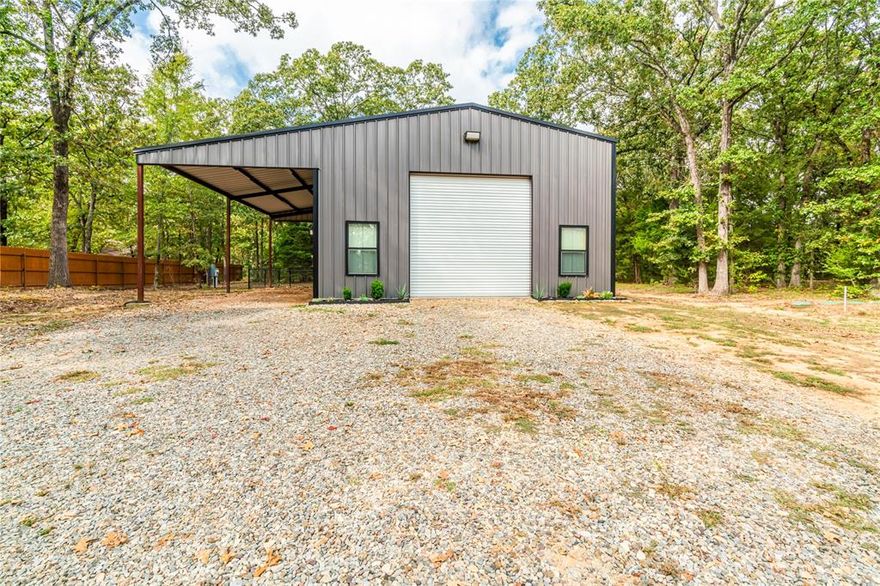 Get ready to have the PERFECT weekend place, downsize or live in Barndominimum while you build your dream home! This home sits on 2.42 deed restricted acres with large mature trees.  This property already has a house pad built for easy start on new construction if desired! The 12 ft tall brand door should accommodate a camper nicely! The large fenced in back yard is a perfect place for kiddos or pets.  The small living quarters gives you an immediate place to live while converting the insulated shop into larger living quarters if desired.  This home is conveniently located on the desirable 1499 corridor in the Caviness community in close proximity to Pat Mayes Lake!  Do not pass up the opportunity to view this adorable Barndominimum in NLISD!