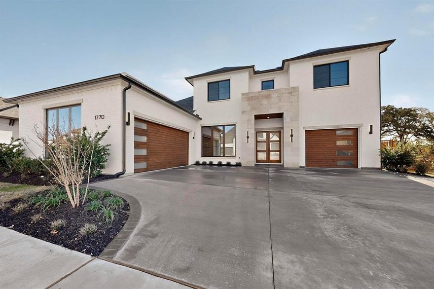 Luxury living is available now in this custom new construction option by exclusive Choate Homes, ideally positioned on a private oversized, North-facing lot in the highly sought-after Viridian community. Enjoy tranquil creek views, mature trees, and the peaceful sounds of Texas nature just beyond your backyard.

The home makes a striking first impression with a modern Lueders stone and painted brick façade, upgraded landscaping, designer gutters, custom 8’ cedar garage doors, and a double front door. Inside, soaring first-floor ceilings, oversized rooms, and walls of black Andersen windows flood the home with natural light. 7” White Oak hardwood floors, a custom staircase with railing, and a Juliet balcony overlooking the foyer elevate the architectural presence, while solid-core doors, spray foam insulation, and a recirculating hot water system reflect thoughtful construction.

The chef’s kitchen features White Oak soft-close cabinets with hardware, upgraded KitchenAid appliances, and an oversized quartz island ideal for entertaining. The adjacent family room showcases a designer linear fireplace and an impressive 16’ sliding glass door, opening to the massive covered patio with a stained tongue-and-groove ceiling and gas log fireplace—perfect for seamless indoor-outdoor living.

The primary suite is a true retreat with spa-inspired finishes, while a secondary downstairs suite is privately located near the walk-through laundry—ideal for guests or multigenerational living. Upstairs, a spacious game room with wet bar opens to an elevated covered deck with peaceful treetop views. Designer lighting and fans enhance comfort throughout, and each bedroom includes access to its own bath.

The oversized garages with epoxy floors provide abundant storage. 

Just moments from Viridian’s lakes, trails, and resort-style amenities, this exceptional home offers a rare opportunity to own one of DFW’s most desirable residences.