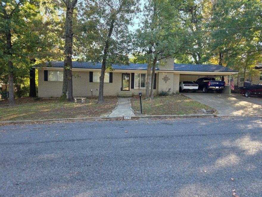 Well-maintained 3-bedroom, 2-bath brick home located next to the Athens Country Club in Athens, Texas. This single-story residence features a traditional floor plan with wood and ceramic tile flooring throughout.

The home offers a spacious den with wood-burning fireplace, a functional kitchen with electric cooktop, oven, microwave, dishwasher, disposal, and pantry, plus central heating and cooling for year-round comfort.

Exterior highlights include a covered patio, fenced backyard with chain link fencing, and two covered carport spaces. This property provides easy access to local amenities, schools, and recreation at Athens Country Club.