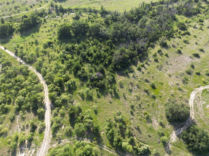 Beautiful 522+- acres with Warren Creek winding through. The native landscape offers great elevation changes providing views that you can see for miles and the possibility of several awesome building sites. There are beautiful live oaks, post oaks, and other hardwood trees adding to the privacy of the ranch and protection for the wildlife and livestock. Another amenity to this picturesque ranch is a watering tank for all animals and recreational fishing. The blank canvas of natural beauty allows for someone to build their own masterpiece. The possibilities are endless with this ranch......your forever home, hunting ranch, recreational ranch, great high fence potential, or combination of them all. The road frontage on two sides, with one being paved, allows great access. Come take a tour of the property and become an owner of a beautiful piece of Texas.