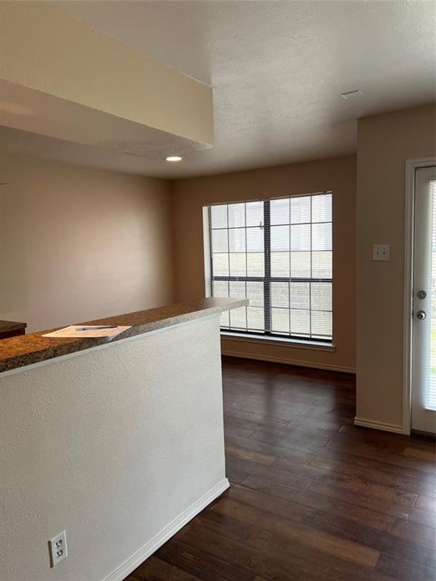 Lakeside Living! Super nice updated condo on Lake Ray Hubbard with updated wood floors, new paint, and new carpet. Downstairs unit. Living area with wood-burning fireplace and French doors that open to a view of Lake Ray Hubbard.  The living and dining rooms have a view of the lake. The kitchen has all appliances and the fridge remains.  Spacious Master bedroom with walk-in closet and private bath.  Huge laundry room with built-in shelves, and a full-size washer and dryer. Plenty of closets and storage. Walk to Captains Cove Marina and Greenbelt Trails. Minutes from the Harbor, shopping, dining, The Harbor, 190, and I30. Buyer or agent to verify room sizes.