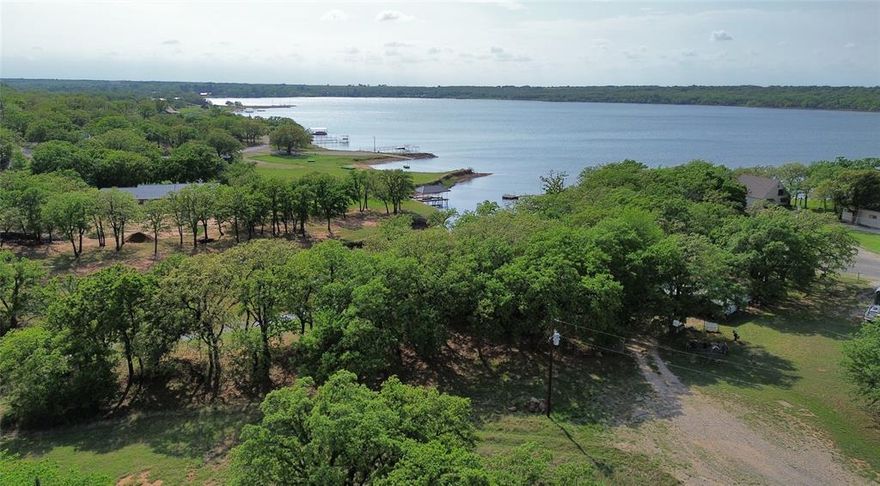 Build Your Lakefront Escape in Gated Nocona Hills! Here’s your chance to create the peaceful lake life you’ve been dreaming of. This beautiful WATERFRONT lot offers the perfect setting for your private retreat—whether you’re ready to build your dream home or bring in a manufactured home. Set in the sought-after Nocona Hills community, this property combines serene water views with the  privacy and security of a 24-7 gated and guarded entrance. With no current septic in place, you still have a great opportunity to customize the property to your needs, and installation should be a straightforward process. Nocona Hills offers an exceptional lifestyle with private lake access, a golf course, campgrounds, a private fishing lake, its own volunteer fire department, an airstrip, and all the charm of relaxed country living. Don’t miss this opportunity to claim your slice of lakefront paradise!