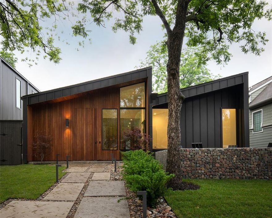 One of a kind single-story modern masterpiece on an enormous 200' deep lot, walking distance to Henderson and Lower Greenville.  Stunning exposed aggregate concrete floors and custom white oak cabinetry provide a warm, organic feel to this contemporary space.  The unique floorplan surrounds several outdoor garden spaces, including a completely secluded outdoor shower within the primary suite.  The perfect mix of open and closed spaces make this home ideal for both entertaining and private living. FAR + DANG design with construction by D best builder Haynsworth Custom Homes.