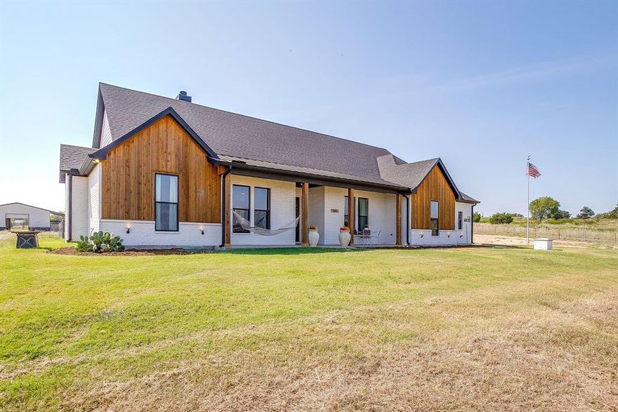 Peaster ISD Home on Acreage WITHOUT the HOA! A truly move in ready Country Living Home with Horse Barn, horse stalls, cross fenced AND Workshop! The Horse barn is currently set up as a 3 Stall with runs extending past the large overhang & has power! Metal Shop on slab pad with power measures 30x20 - if you have projects then this is the place to be! This custom built KW Home offers a fantastic life friendly layout! Open plan gourmet Kitchen with gas cooktop - with pot filler, double ovens, farmhouse sink & huge Island is beautiful then add in the massive walk in pantry... as if that isn't amazing enough to store all the best treats - you have a FULL BUTLERS PANTRY suite tucked away off the Kitchen, complete with second sink, drinks station & more storage than you could dream of! The home office, with closet, overlooks the beautiful front acreage & is hidden by the custom built barn sliding door. Split Bedrooms, walkthrough Primary Closet connected to the Laundry room, located conveniently off the mudroom entry area from your HUGE 3 car garage. The private guest bedrooms each have their own vanity & walk in closet, with Jack & Jill Bath shower toilet combo. Cleverly planned half bath is situated at the rear of the home offering privacy AND a perfect location should you wish to add a pool! The covered back patio is the chef's kiss with its views of the horse barn while tucked under the shade with corner wood burning fireplace. If you are looking for the true custom home feel instead of settling on a spec home, without the added restrictions of a HOA then this is the one you want to hurry up and see! Bring the horses & start enjoying true countryside lifestyle today.