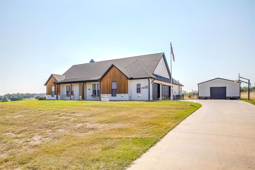 Peaster ISD Home on Acreage WITHOUT the HOA! A truly move in ready Country Living Home with Horse Barn, horse stalls, cross fenced AND Workshop! The Horse barn is currently set up as a 3 Stall with runs extending past the large overhang & has power! Metal Shop on slab pad with power measures 30x20 - if you have projects then this is the place to be! This custom built KW Home offers a fantastic life friendly layout! Open plan gourmet Kitchen with gas cooktop - with pot filler, double ovens, farmhouse sink & huge Island is beautiful then add in the massive walk in pantry... as if that isn't amazing enough to store all the best treats - you have a FULL BUTLERS PANTRY suite tucked away off the Kitchen, complete with second sink, drinks station & more storage than you could dream of! The home office, with closet, overlooks the beautiful front acreage & is hidden by the custom built barn sliding door. Split Bedrooms, walkthrough Primary Closet connected to the Laundry room, located conveniently off the mudroom entry area from your HUGE 3 car garage. The private guest bedrooms each have their own vanity & walk in closet, with Jack & Jill Bath shower toilet combo. Cleverly planned half bath is situated at the rear of the home offering privacy AND a perfect location should you wish to add a pool! The covered back patio is the chef's kiss with its views of the horse barn while tucked under the shade with corner wood burning fireplace. If you are looking for the true custom home feel instead of settling on a spec home, without the added restrictions of a HOA then this is the one you want to hurry up and see! Bring the horses & start enjoying true countryside lifestyle today.