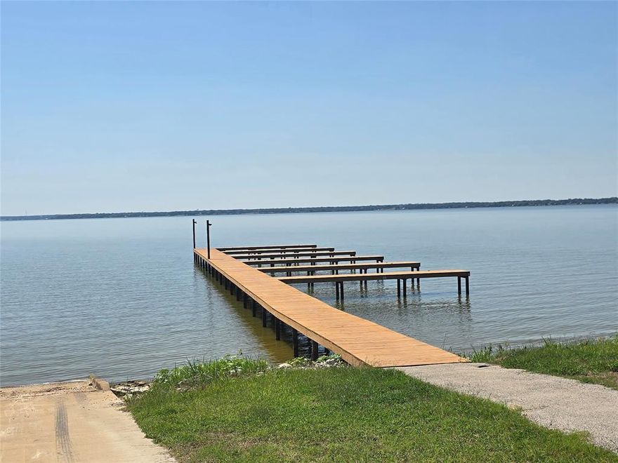 Build your dream home in this sought-after community, offering resort style living and first class amenities.  This oversized 100x300 homesite provides plenty of space for your vision, with mature trees along the back for added privacy.  Enjoy access to a million-dollar amenity center featuring an infinity pool, a community dock for lake access and the peace of mind that comes with a gated neighborhood.  This is an amazing opportunity to secure a spacious lot in a premier waterfront community.