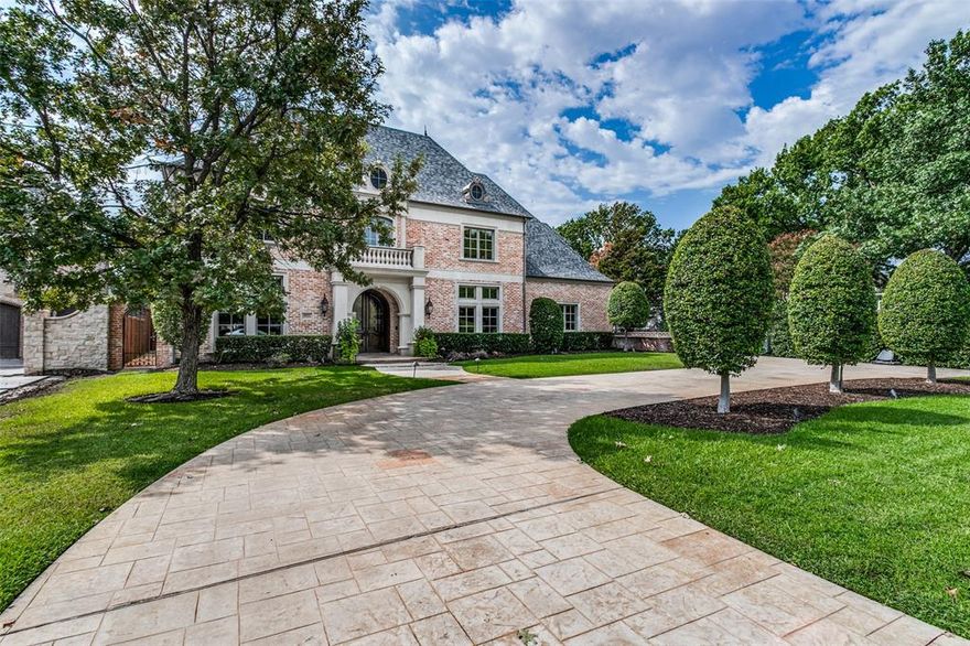 This gorgeous updated family home in Preston Hollow boasts five bedrooms each with its own bathroom. The primary bedroom and one other bedroom are located downstairs in a split bedroom floor plan. The exquisitely remodeled primary bathroom features his and hers closets and a commercial quality steam shower. The home also has a half bathroom upstairs and downstairs for a total of seven bathrooms. In addition this fabulous family home has a large study and library with an updated fireplace and Samsung Frame TV, a freshly renovated wine room, a game room and a media room with surround sound. The state of the art kitchen includes a 60 inch Wolf Range, warming drawer, dual dishwashers, a Sub Zero refrigerator and freezer and much more. There is a wet bar which includes Uline refrigerator drawers. The three car garage includes a high speed 220v Tesla charger. Outside you will find a gazebo with running water, grill and cooktop and another grill and warming drawer on the patio.