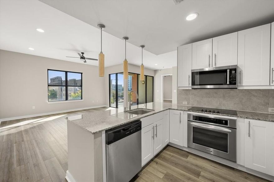 Location location! Beautifully updated and in move in condition! Gated parking in the building, community pool, secure building and access.  This condo has new LVP flooring throughout, full interior paint, new mirrors and dishwasher, disposal, backsplash in the kitchen. Open living area and dining -flex space with view of balcony.  The kitchen features granite counters, breakfast bar, stainless steel appliances, refrigerator remains.  Private primary suite, walk in closet, tub, dual sinks, upgraded master shower enclosure and large closet. Secondary bedroom is oversized and has a closet and adjoining bath. This bath has been upgraded with new vanity, granite, undermount sink and mirror. Vacant and ready for occupancy today.