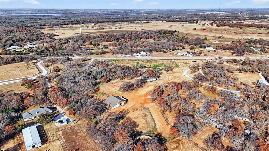 Mountain Springs Ranch is surrounded by large ranches and high-end properties in one of the most desirable locations of North Texas. This 8 acre property includes open pastures, mature trees, and sandy loam soil. With a new, dedicated entrance on FM 922, the ranch provides excellent access while maintaining a quiet, rural setting.  The land features approximately 40 feet of elevation change, adding character, views, and natural drainage.  Improvements include an 8 stall cinder block barn, a recently remodeled mobile home, and new perimeter fencing.  Electric and water are on site, allowing for immediate use. Whether you are looking to build a private estate or invest in a premier piece of North Texas land, Mountain Springs Ranch is both functional and inspiring.