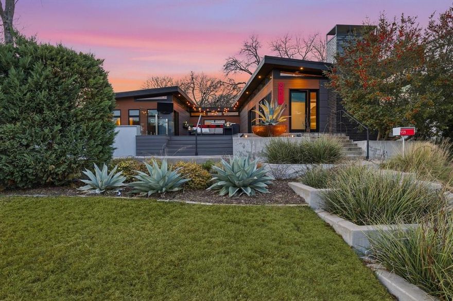 With views overlooking White Rock Lake Park, this architect-designed modern custom in The Peninsula presents a rare opportunity for private, design-driven living at 9211 E Lake Highlands Dr. Surrounded by nature and shaped by shifting light throughout the day, the home delivers a peaceful living experience deeply connected to its natural setting. Designed through a collaboration between a Seattle-based architect and local Dallas designers and builders, the residence reflects a design-forward approach rooted in site-specific architecture. Clean lines, curated materials, and thoughtful spatial planning shape everyday living, complemented by expansive glass and clerestory windows that fill the interiors with natural light. The home is carefully integrated into the natural hillside topography, with terraces and pathways reinforcing the connection between architecture and landscape. Living spaces unfold through intentionally defined zones anchored by a central courtyard and a private pool with a mosaic-tiled water element, creating a seamless connection between the home and its surroundings. Construction quality is a defining feature, highlighted by a Pier & Beam foundation drilled to some 20’ to bedrock and engineered for long-term durability. A layered subfloor system, modern materials, and energy-conscious building practices further enhance performance and longevity. Lighting design enhances both form and function, with a professionally designed Lutron preset system that earned an IES Illumination Design Award of Merit. Custom Emtek hardware, Milgard metal windows, expansive sliding doors, and organic white quartz stone countertops contribute to the home’s refined elegance. New Surestone composite decking enhances the courtyard and walkways with superior stability and traction, while Karndean Vulcano luxury vinyl tile adds a stone-inspired look with waterproof performance and comfort underfoot. A separate office structure offers flexible space for work or studio use.