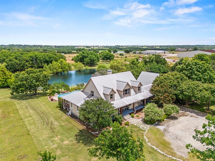 Welcome to your dream country escape with no HOA & over 4,077 sf air-conditioned space which includes the 418 sf garage-apartment! Nestled on 5.6+ scenic acres in desirable Rockwall County, this 3,659 sf rustic, farm style home blends timeless charm w-functionality. You’ll find perfectly-weathered, recently re-stained soft pine floors, massive solid oak beamed ceilings & a see-thru fireplace that adds warmth & character to the newly-painted kitchen, dining room, living room. Kitchen features gas cooktop, vintage decorative vent hood, ample cabinetry, counter space & walk-in pantry. Main level includes spacious primary BR with ensuite bathroom with jetted tub, extra bedroom currently dedicated home office space, utility room & 2nd full bath. Upstairs are 3 add’l bedrooms w-walk-in closets, Jack & Jill bath & versatile common area—ideal for a 2nd living area, game room, or study space. 

Enjoy outdoor living w-1,350 sf wrap-around porch—part of it screened-in—& sparkling, resurfaced pool w-waterfall. Property has mature trees & a picturesque 1.5 +-acre, stocked fishing pond. Detached 2-car garage includes an apartment above—perfect for guests, rental income, Airbnb-VRBO space, extended family-MIL suite, home office, or media room. Apartment features full bath, kitchenette w-sink & refrigerator & stove hookups, as well as a tankless water heater for efficiency & comfort. Metal building is ideal for a workshop, she-shed, or extra storage. 

The one-owner home also features brand new Low-E, energy core windows upstairs, new gutters & downspouts, a pier & beam foundation, irrigation system in flower beds & backyard, money-saving geo-thermal heating & cooling system & metal roof w-new dome-capped screws. More than just a home, it’s a lifestyle of space, serenity & possibility, just 3.5 miles south of I-30. 

NOTE: Owners are offering a $10,000 flooring allowance to replace carpet in all bedrooms.