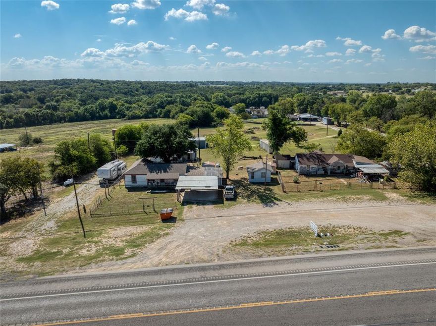 + or - 2.5 acres with Highway 199 frontage.  High visibility location with high traffic count has commercial potential for your business and rental income potential from the 3 residences and the large shop on the property.  There is a well and two septic systems on the property.  Located minutes from local schools, shopping, and dining, this property is only 30-40 minutes from the Metroplex.