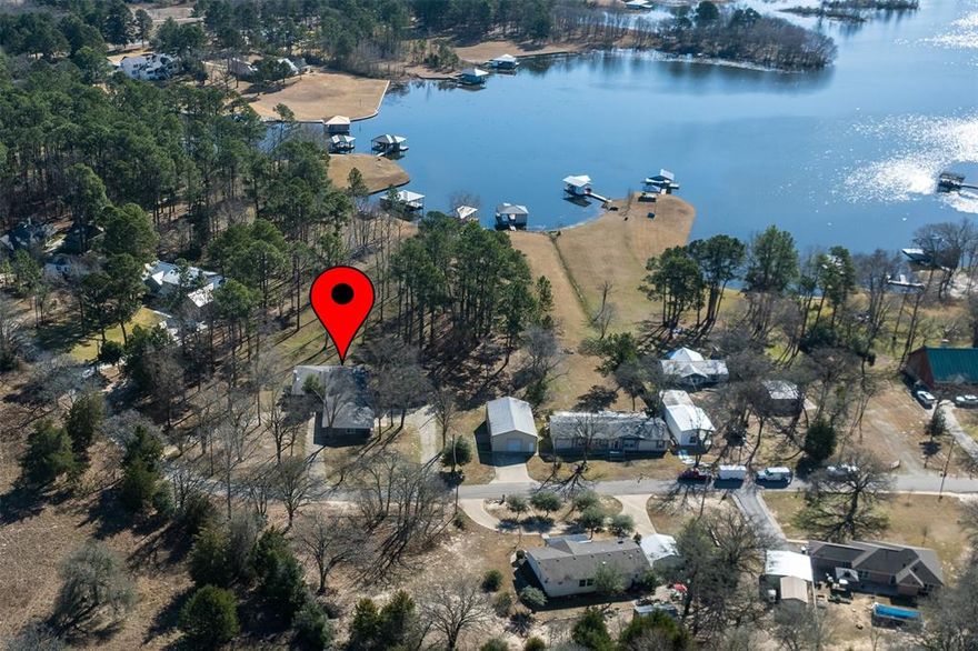 Welcome to this charming lakefront escape, where peaceful mornings, sparkling water views, and unforgettable sunsets become part of everyday life. Nestled along the shoreline, this beautifully maintained home blends rustic warmth with modern comfort, offering the ideal setting for weekend getaways, family gatherings, or full-time lakeside living.

Step inside to an open, sun-filled layout featuring large windows that frame panoramic views of the water. The spacious living area flows seamlessly into a well-appointed kitchen, perfect for cooking, entertaining, or simply enjoying the scenery. Cozy bedrooms provide a restful retreat, while the primary suite offers its own private vantage point of the lake.

Outside, a generous deck and shaded patio create multiple spaces for relaxing or hosting. A private dock gives you direct access to boating, fishing, swimming, and all the lake adventures you can imagine. Mature trees, gentle breezes, and the sound of lapping water set the tone for a truly serene environment.

Whether you're seeking a peaceful sanctuary or an active waterfront lifestyle, this lake house delivers the best of both worlds. Come experience the magic of lakeside living — your next chapter begins here.