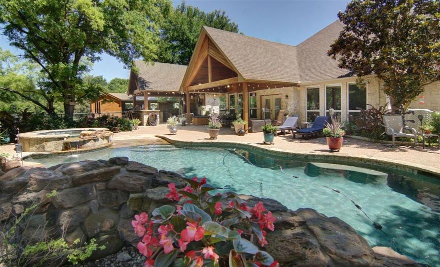 Exquisite Country Estate on 10+ Acres in Aledo ISD
5 Beds, 4.5 Baths, 2 Master Suites, Guest Quarters, Pool, Barn, Shop, AG Exempt

Welcome to a luxurious country retreat tucked away among mature trees on over 10 pristine acres in the highly acclaimed Aledo ISD. This immaculate, meticulously maintained estate offers exceptional privacy, versatility, and elegance—ideal for multi-generational living or entertaining on a grand scale.

Residence Highlights:

5 spacious bedrooms, including two primary suites

4.5 well-appointed bathrooms

Two full kitchens perfect for extended family or guest quarters

Formal and casual dining spaces (3 total)

Two large living areas plus a versatile flex room

3-car garage plus porte cochere for additional covered parking

Ample storage with floor decking above the garage

Outdoor Amenities: Resort-style pool with waterfall and spa, fully equipped outdoor kitchen for alfresco entertaining, two koi ponds surrounded by professional landscaping and lighting.

3 stall barn with tack room—ideal for horses or hobby farming, 3-bay shop for equipment, vehicles, or workspace. Property is fully fenced and cross-fenced with pipe and no-climb wire. 9 acres AG exempt a rare and valuable benefit.

Recent Upgrades & Features: Freshly painted interior, including baseboards, new tile and upgraded flooring throughout, newer energy-efficient HVAC systems, newer windows and window treatments (plantation shutters and cellular shades)

Asphalt driveway and updated well pump, stainless steel appliances, water heaters, and enhanced outdoor lighting around pool area

From the tranquil koi ponds and lush landscaping to the expansive, functional layout, this estate offers a true sanctuary just minutes from town. Whether you're looking for peaceful country living or an entertainer’s dream, this property delivers on all fronts.

Come experience the best of refined rural living.  Schedule your private showing today.