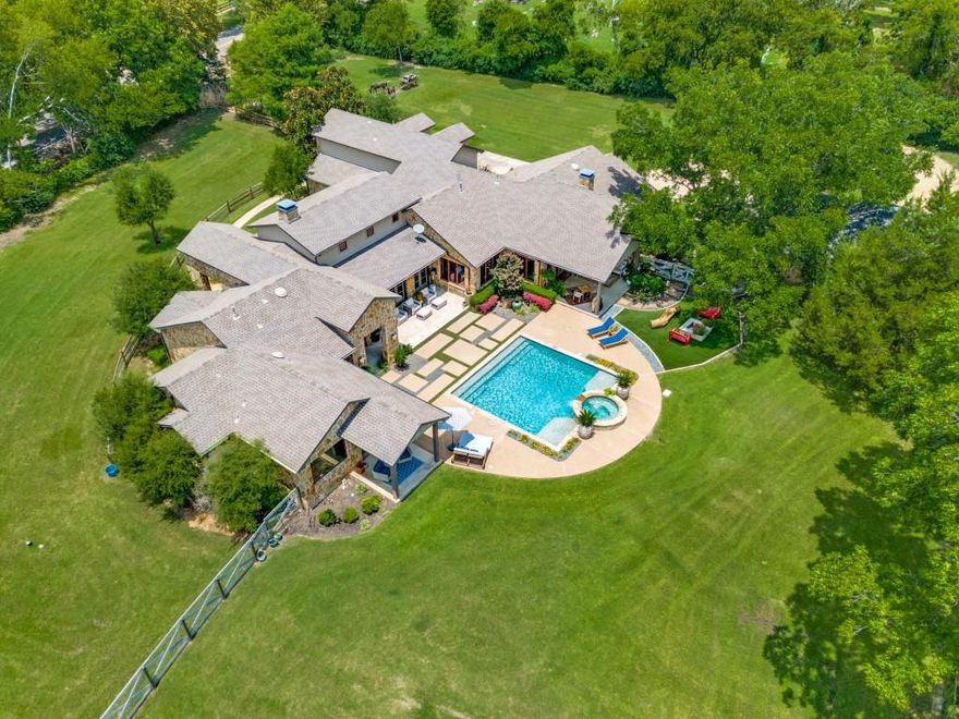 Designed specifically for horses, luxury, privacy, and with a touch of attitude, this gated 7.23-acre Sunnyvale estate delivers the ultimate lifestyle. Just 15 minutes from downtown Dallas and zoned to the exemplary-rated Sunnyvale ISD, the custom-built main house stuns with 30-foot beamed ceilings, a floating live-edge staircase, hand-selected finishes, and expansive floor-to-ceiling windows offering panoramic views of rolling pastures, a stocked pond, and mature trees.

Blending rustic charm with modern sophistication, this home is ideal for peaceful family life or unforgettable entertaining. Start your mornings with breathtaking sunrises, unwind by the resort-style pool, or host weekend gatherings while horses graze nearby. The 2-bedroom, 1,200 sq ft all-stone guest house is ADA certified and income-producing—perfect for multigenerational living, guests, or even a private trainer’s quarters.

Horse lovers will appreciate the professional-grade amenities, including a 4-stall barn with tack room, secure pipe and no-climb fencing, and cross-fenced pastures designed for optimal equine care. The quiet, close-knit community of Sunnyvale offers country serenity with convenient access to city life, making it a dream destination for those seeking both tranquility and connection. This is refined horse-country living—without compromise.