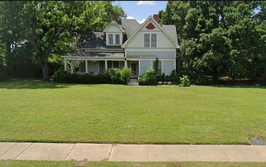 Gorgeous 3924 square foot home built in 1907 arranged beautifully on 1.3728 acres with a 45' wrap around porch located just blocks south of the very sought after downtown Grandview, Texas! Features one very large downstairs primary bedroom with a fireplace, large ensuite, and walk in closet, 4 upstairs bedrooms, 2 additional bathrooms, massive living room, parlor, den, upstairs common area, sunroom, 2 mud rooms, formal dining room, and large kitchen. All original hardwood trim, doors, and floors along with a breathtaking staircase. Situated on this large corner lot is also a 12 X 20 carriage house, 14 X 20 workshop, 16 X 20 storage building, and a 24 X 24 two car attached garage. In my opinion it is one of the most beautiful properties in Grandview, Texas. It would with some work make a terrific single-family home, bed and breakfast, or wedding venue. It is a must see! Book your showings now while it's still available!!!!