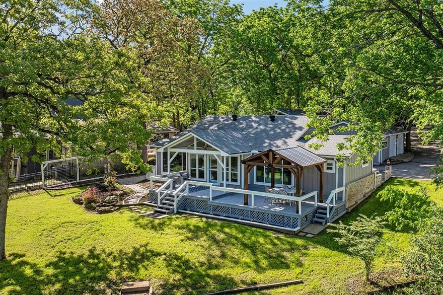 Discover the perfect blend of modern updates, classic charm, and lakeside serenity in this beautifully renovated 2-bedroom, 2-bath home, and just steps away, a separate 350 sq ft guest house offers private accommodations with its own full bathroom—perfect for extended family, friends, or teens &kids. The bright, open layout of the main house features new engineered hardwood floors throughout and fresh interior paint that enhances its clean, inviting feel. The living and dining areas flow seamlessly into a newly updated kitchen with quartz countertops, a large center island with bar seating, and stylish new fixtures—all with relaxing lake views. The spacious primary suite is a true retreat, with a fully renovated en-suite bathroom featuring a standalone soaking tub, new walk-in shower, modern vanity, and updated lighting. The second bedroom and full bath provide comfort and flexibility with matching finishes. Outdoor living is where this property truly shines. Enjoy 175 feet of prime lake frontage, and a quick boat ride to open water. A freshly updated boathouse with a boat lift makes lake access effortless, while the large covered back patio provides a perfect space for morning coffee, evening sunsets, or weekend grilling. A newly landscaped large backyard with open green space is ideal for pets, play, or peaceful relaxation. Additional highlights include a spacious RV carport with full hookups, new ductwork, a tankless water heater, and modern finishes throughout. From the stylish interior to the functional outdoor spaces, this turnkey lakefront home offers comfort, charm, and lasting quality. Whether hosting guests, unwinding by the water, or enjoying the peaceful setting, this property offers great Cedar Creek Lake living in a beautifully refreshed, move-in-ready space.