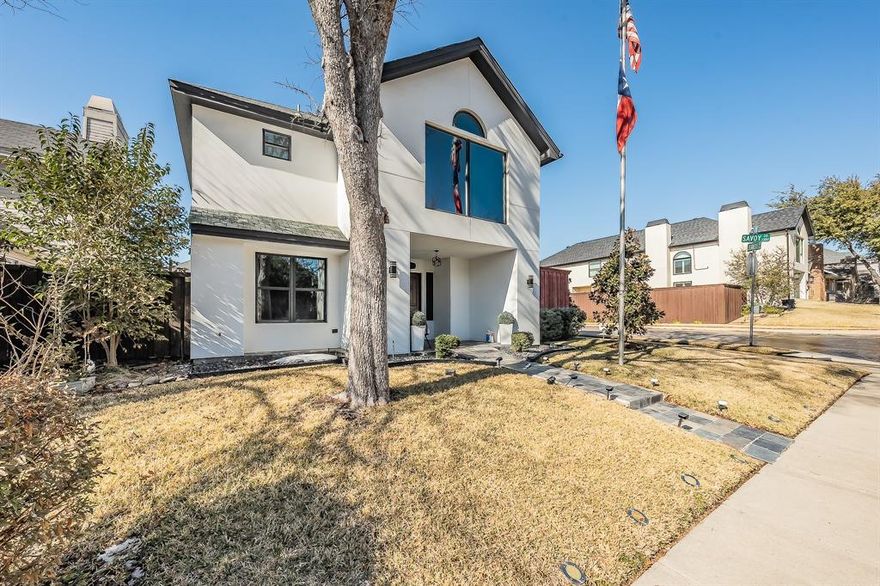 The striking modern façade introduces this beautifully designed corner-lot residence with refined style and thoughtful spaces throughout and no HOA.
Experience refined living at 1349 Jeanette Way, a distinctive Carrollton residence offering 4 bedrooms, 3 full bathrooms, and 2,430 square feet of thoughtfully designed living space. The home features a private guest suite with full bath located on the main level, ideal for multigenerational living or elevated guest accommodations or you could use it as your own office.

The kitchen is both functional and stylish, featuring abundant cabinetry, cascading granite countertops, and generous prep space. The refrigerator is negotiable, adding flexibility for the buyer. Natural light fills the living area, highlighting the soaring ceilings and dramatic floor-to-ceiling fireplace, creating a bright and inviting atmosphere and flowing seamlessly into the formal dining area—ideal for entertaining.

The primary suite is a true retreat with fireplace and private suite with skylights. Upstairs includes a versatile bedroom with oversized walk-in closet, an additional bedroom, and a loft ideal for a game room or second living area.

 The garage features epoxy flooring, enhancing both durability and presentation. Parking is exceptional with a 2-car garage plus a carport accommodating up to three additional vehicles.

Outdoors, enjoy a private backyard enclosed by an 8-foot fence with a large, covered patio, perfect for entertaining or quiet enjoyment year-round. Conveniently located near major highways, shopping, and dining, this home blends comfort, sophistication, and versatility in an established Carrollton neighborhood.